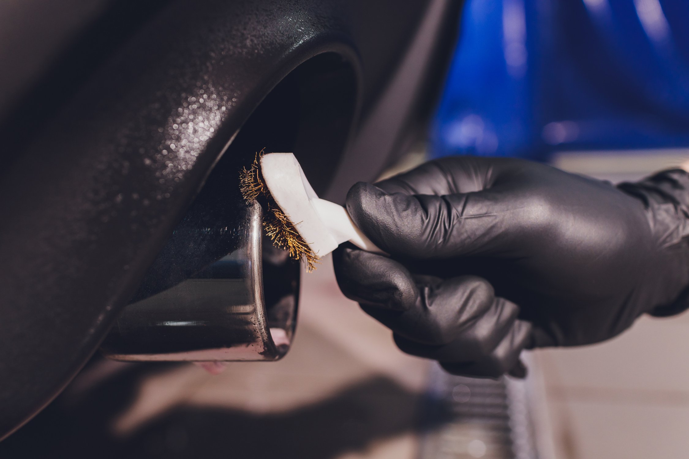 Car exhaust pipe with soap. Car wash background. brushing